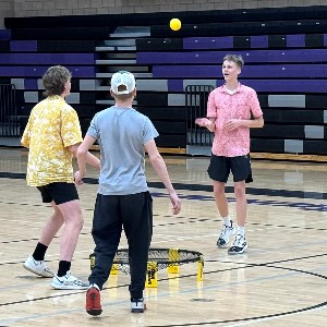 Boys playing spikeball