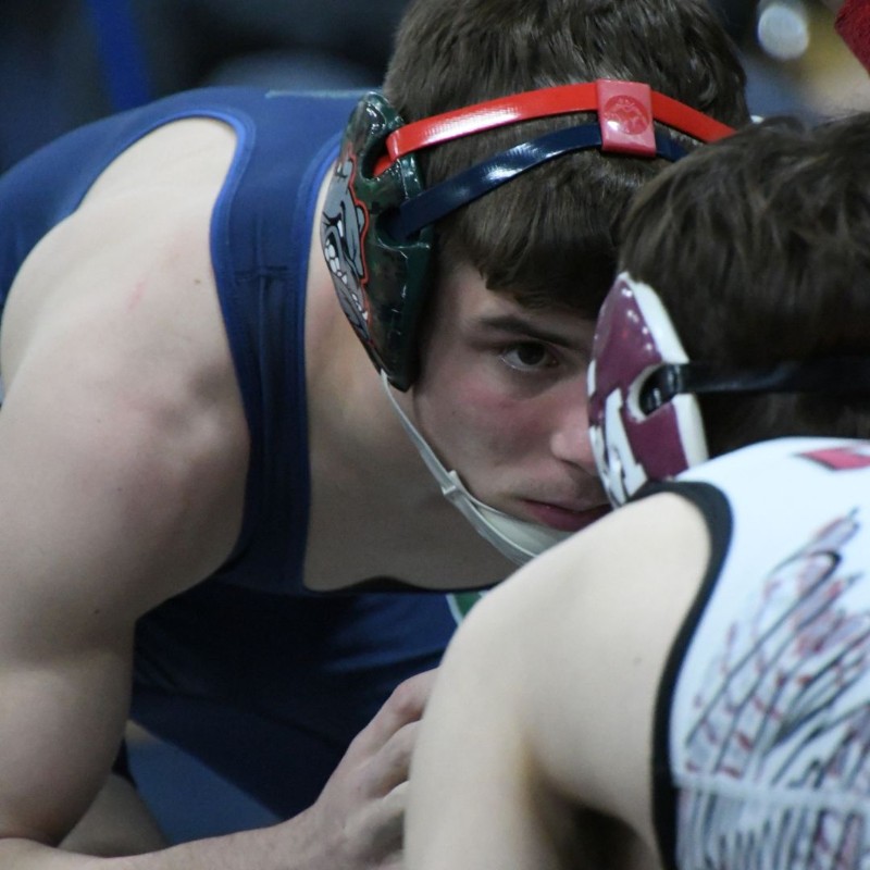 Wrestler looking at another in the eye