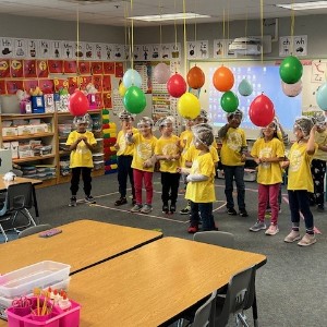 Students wait to pop glitter filled balloons. 