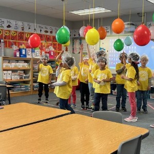 Students wait to pop glitter filled balloons. 