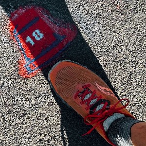 Liberty bell stamped on sidewalk with the number 18 in the middle