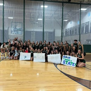 The Cheer Team poses on the gym floor.