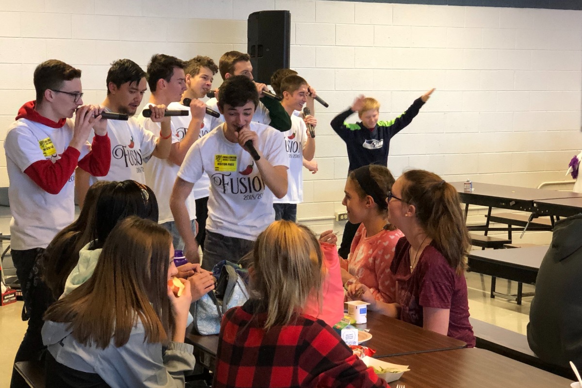 PCHS choir student sing for other students in the lunchroom.