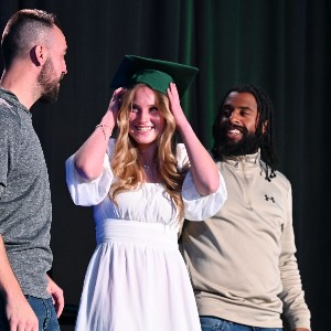 Three adults smiling and laughing