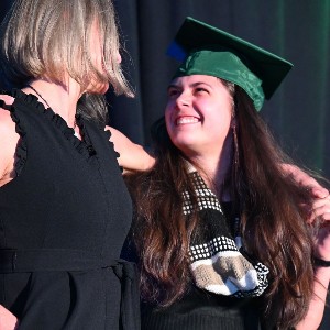 Girl and Mom looking at each other and smiling