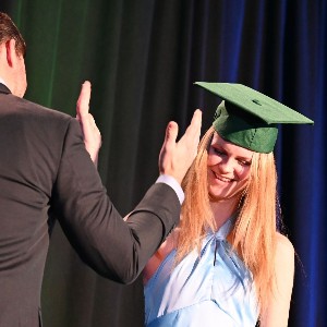 Student and parent giving high five