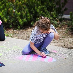 TDVA students decorate their sidewalk with chalk drawings.