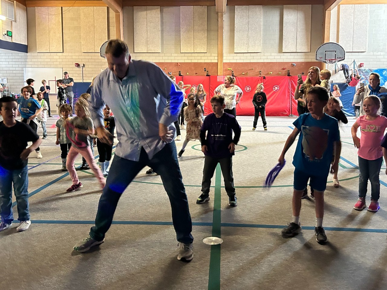 adults and students dance at a party hosted by the pto.