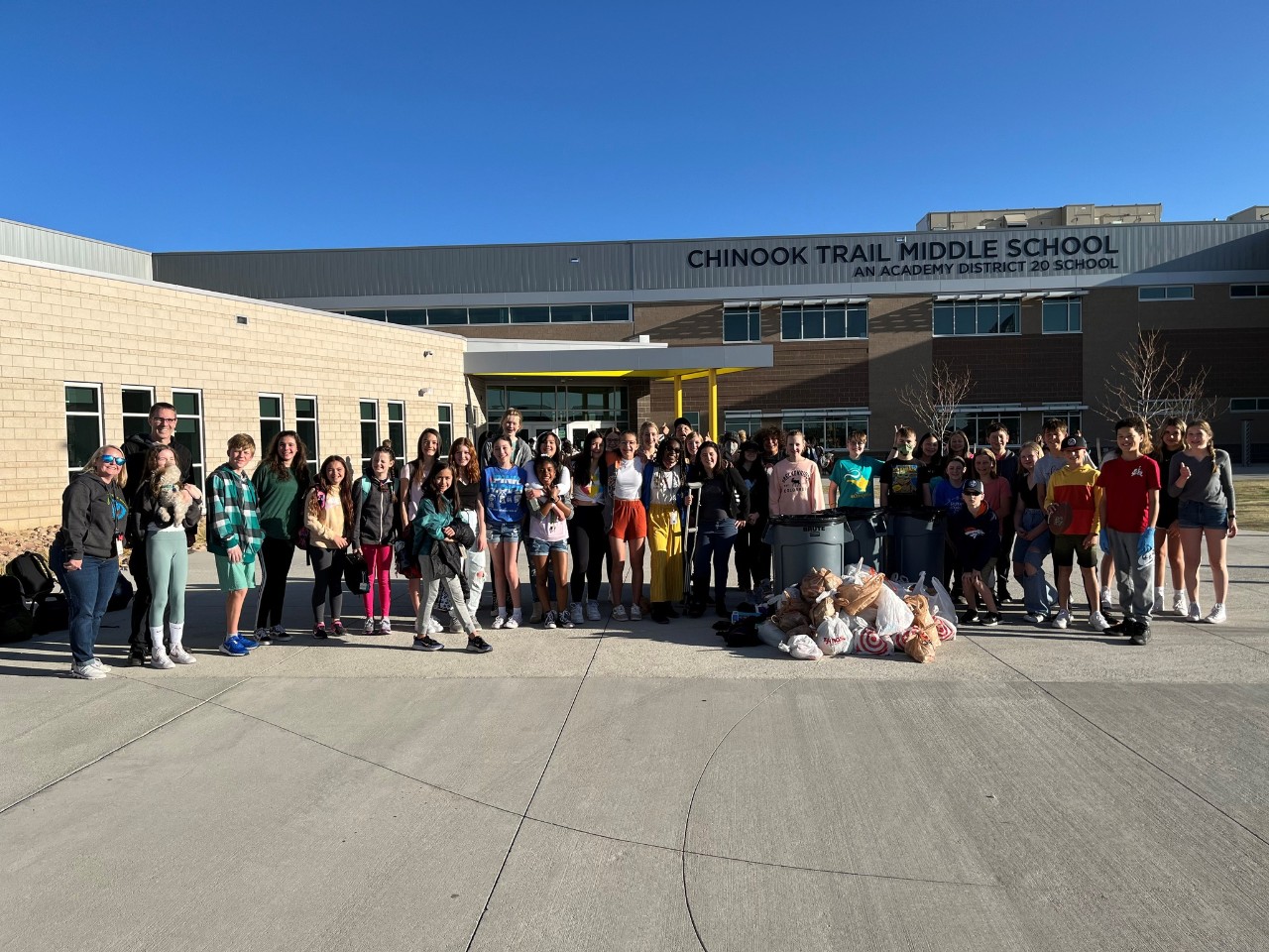 staff, students and volunteers work on a cleanup project