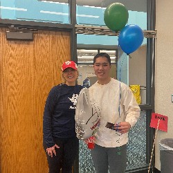 Student holding balloons