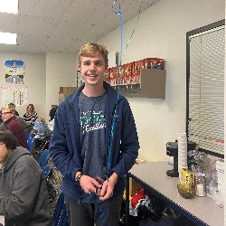 Student smiling holding balloons