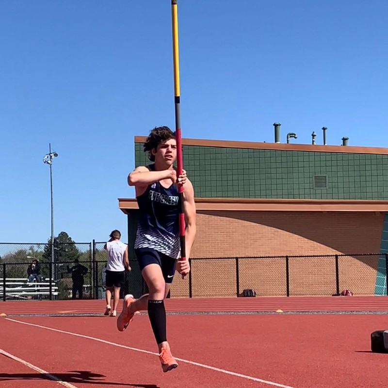 Student running with pole for pole vault