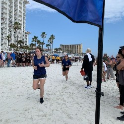 Members of the Raider Team running on the beach