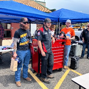 Sean Foster smiles for a photo in front of his new tool box