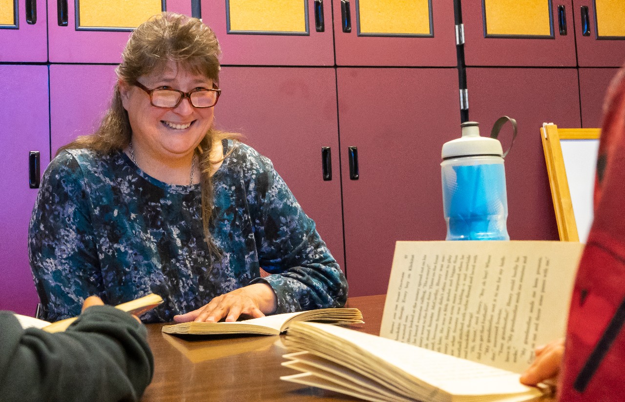 Sherry Adamcyk smiles while reading to her students 