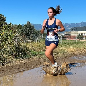 Girl running through mud