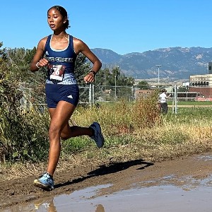 Girls running on muddy course