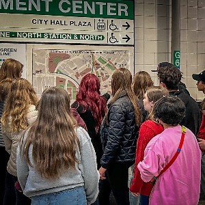Liberty students and staff look at the subway map in Boston while at their conference in the city.