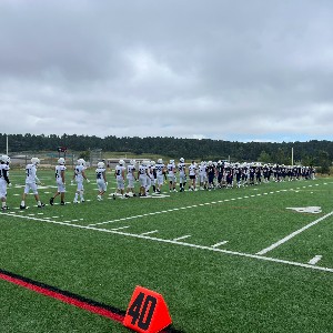 Football players shake hands at the end of the game