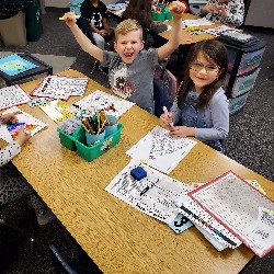 Students coloring with the principals