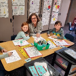 Students coloring with the principals