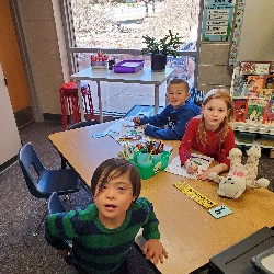 Students coloring with the principals