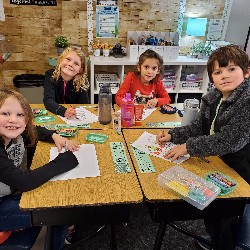 Students coloring with the principals