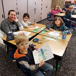 Students coloring with the principals