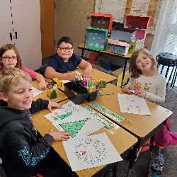 Students coloring with the principals