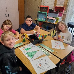 Students coloring with the principals