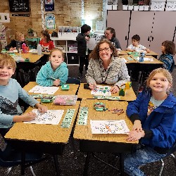 Students coloring with the principals