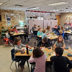 Students coloring with the principals