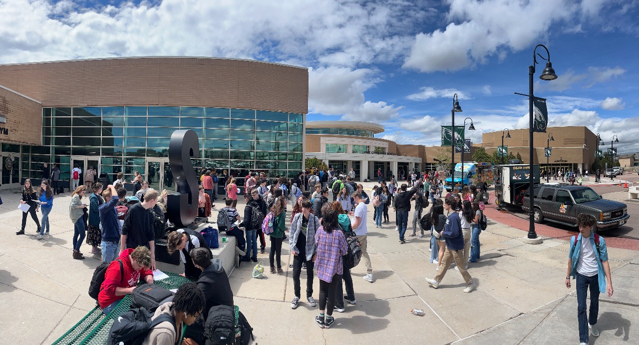 Students socializing in front of the school building