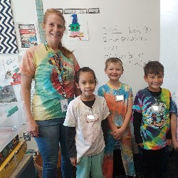 Teacher and students wearing tie-dye shirts