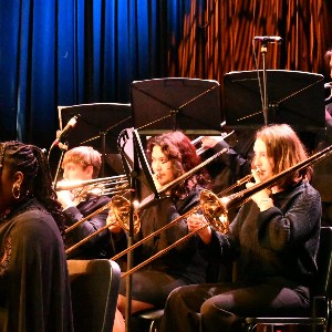 Group of musicians playing in low light