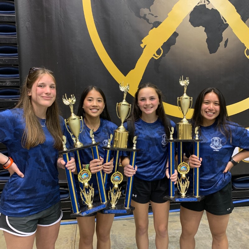 Four females from D20's Air Force JROTC holding trophies at the end of the JROTC National Championship in April 2022