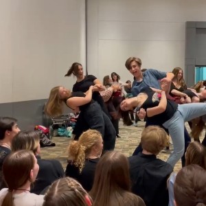 Attendees participating in a dance workshop at ThesCon 2023