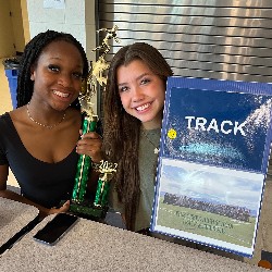 Track Athletes pose with trophy at club fair