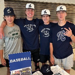 Four boys with baseball caps