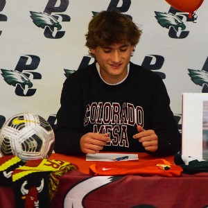 Athlete preparing to sign his National Letter of Intent.