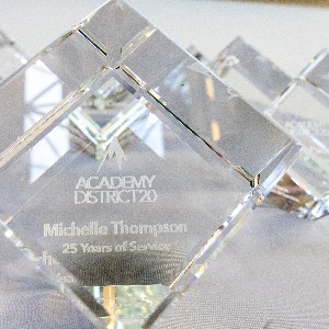 A crystal cube with Michelle Thompson's name signifies the award for 25 years of working at ASD20