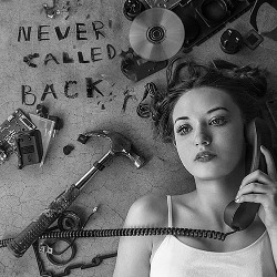 An image of a young woman on a corded phone.