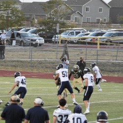 The AAHS football team competes on the field.
