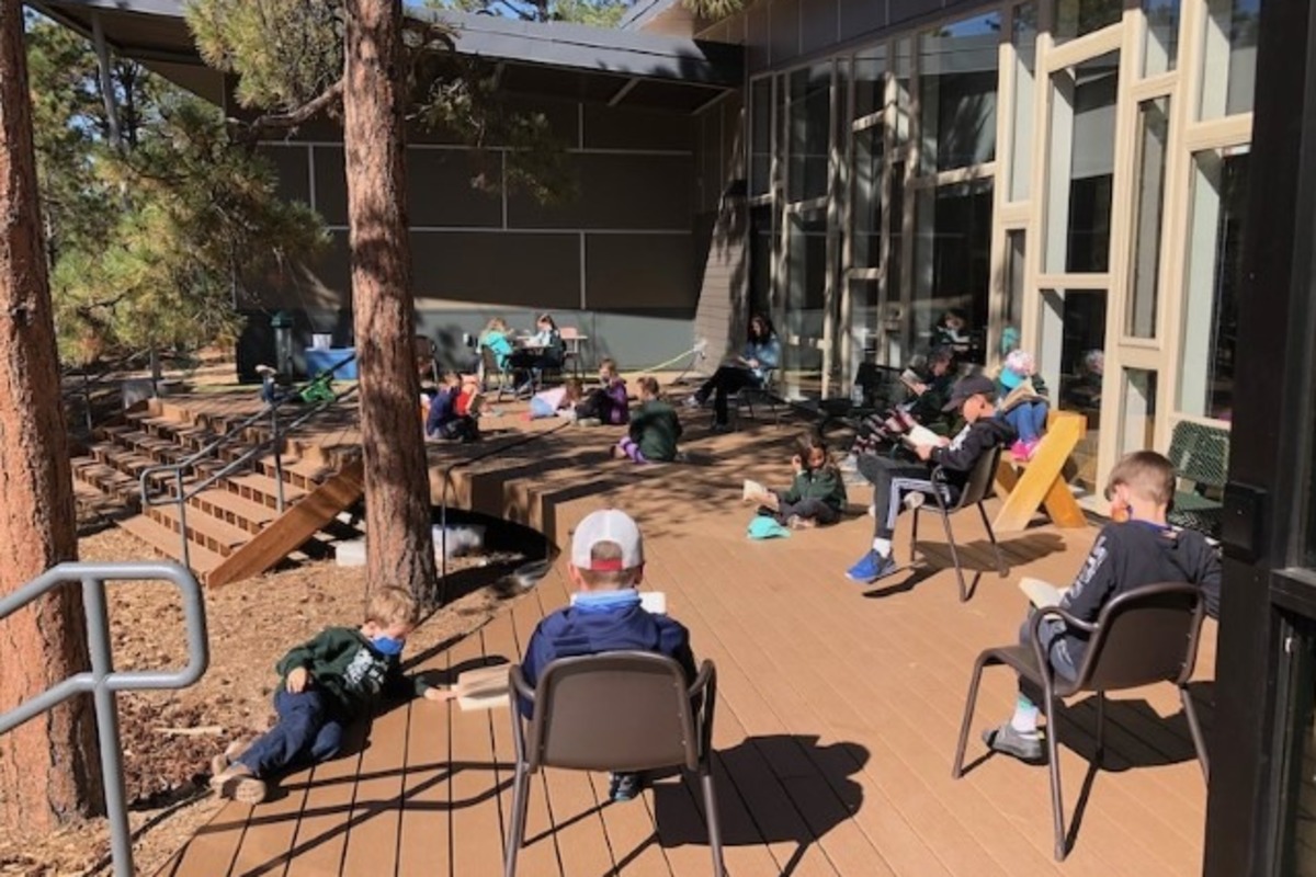 A class of students studying outside.