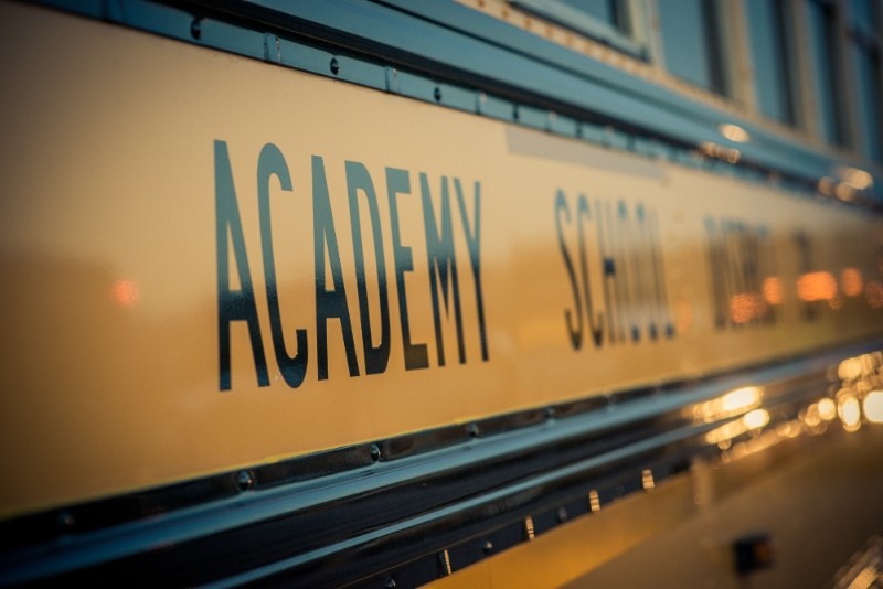 A close up view of the words "Academy School District 20" on the side of one of our buses.