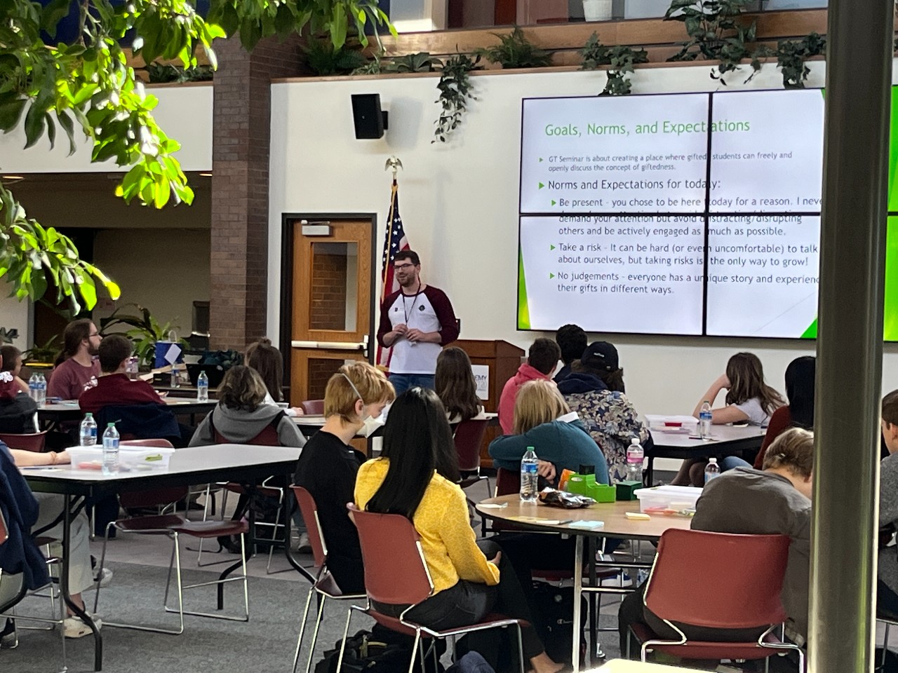 Students listen to guest speaker in the Atrium at D20's Central Office.