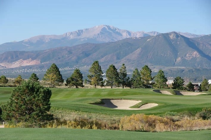 A Colorado Springs golf course with Pikes Peak in the background.