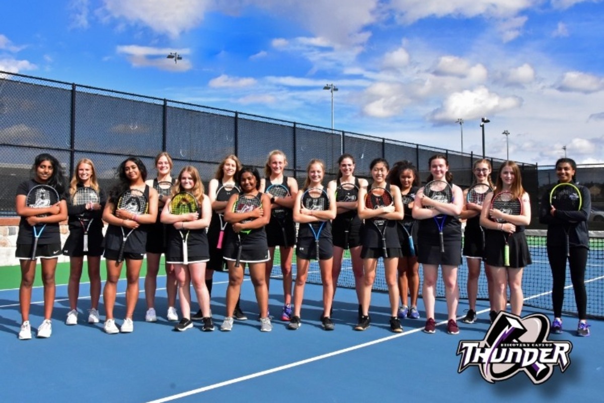 The 2021 girls Tennis team posing on the courts.