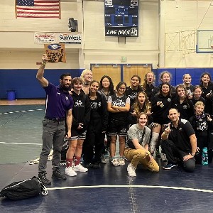 Group photo on wrestling mat