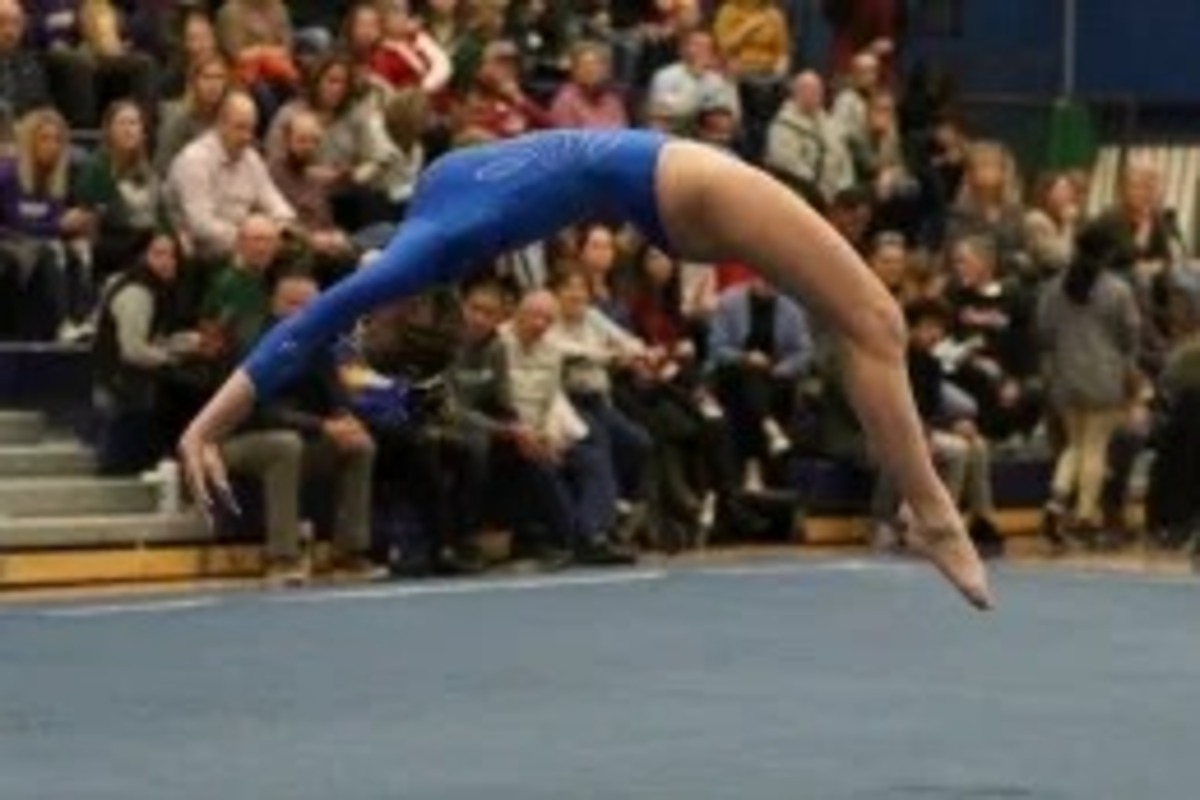 A gymnast performs on the mat during a competition.